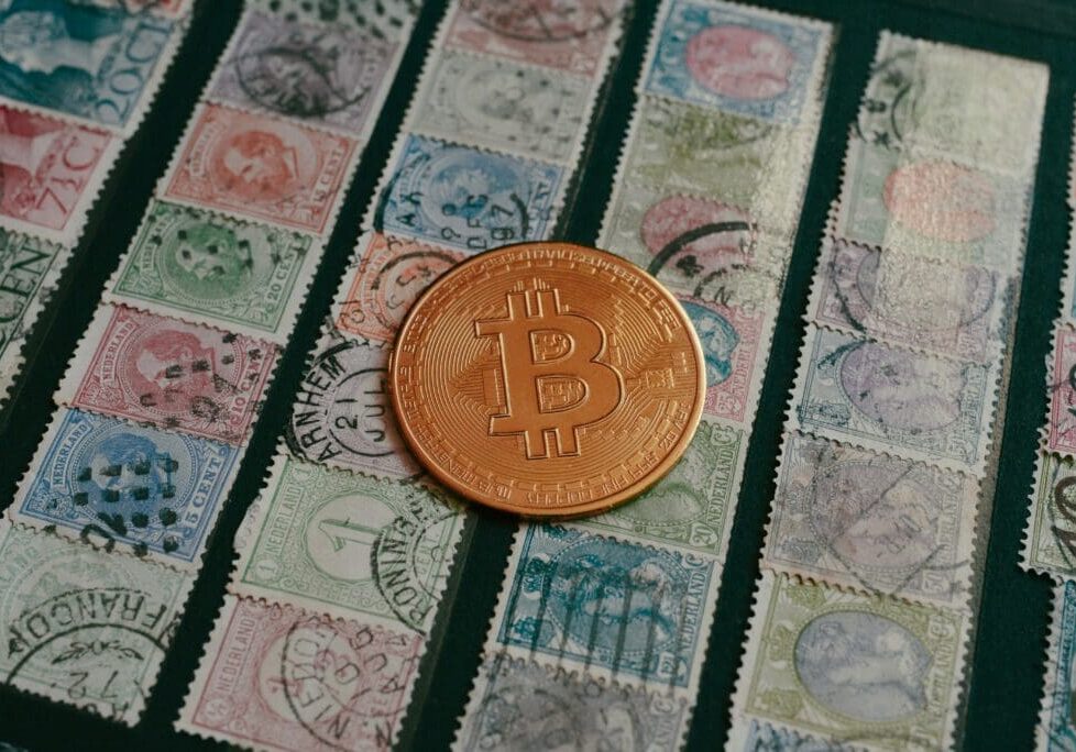 Bitcoin coin on vintage postage stamps