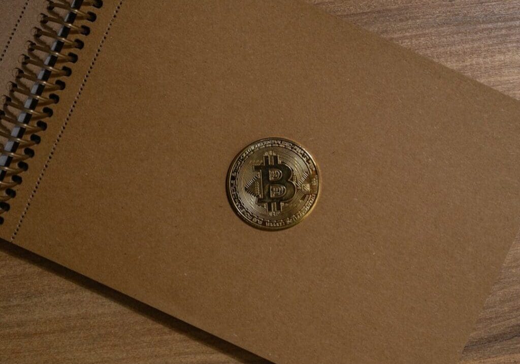 Bitcoin coin on a brown notebook