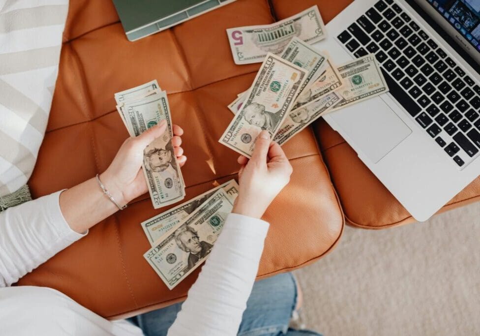 counting-cash-on-sofa-scaled