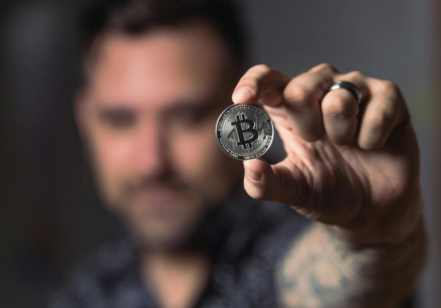 man-holding-bitcoin-scaled