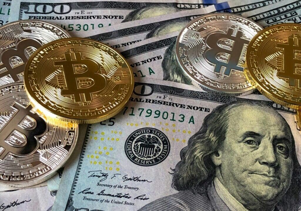 Bitcoins and dollar bills currency comparison